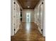Hallway featuring hardwood flooring and decorative doors leading to other rooms at 300 Kelly St, Statesville, NC 28677