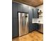 Contemporary kitchen featuring custom cabinetry, stainless steel refrigerator, and hardwood floors at 300 Kelly St, Statesville, NC 28677