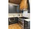 Modern kitchen boasts gray cabinets, stainless appliances, and a wooden range hood at 300 Kelly St, Statesville, NC 28677
