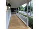 Charming porch with new wooden floor and a white railing, ideal for enjoying the neighborhood at 300 Kelly St, Statesville, NC 28677