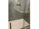 Modern walk-in shower with green subway tile, honeycomb floor, and glass enclosure at 300 Kelly St, Statesville, NC 28677