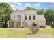 Expansive backyard featuring a covered porch, well-maintained lawn and garden beds, ideal for outdoor enjoyment at 3007 Sandbox Cir, Indian Trail, NC 28079