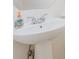 Close-up of a white bathroom sink with modern faucet and pedestal base at 3007 Sandbox Cir, Indian Trail, NC 28079