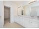 Bathroom with double vanity, ample storage, large mirror, and an adjacent walk-in closet at 3007 Sandbox Cir, Indian Trail, NC 28079