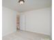 Clean bedroom with neutral walls and carpet, featuring a door to another area at 3007 Sandbox Cir, Indian Trail, NC 28079
