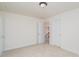 This is a bedroom with beige walls, light beige carpet, and white doors. There is a ceiling light fixture at 3007 Sandbox Cir, Indian Trail, NC 28079