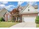 Brick house with driveway leading to two car garage and lush front lawn at 3007 Sandbox Cir, Indian Trail, NC 28079