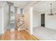 Open entryway featuring hardwood floors, stairs to the upper level, and a view into the living room at 3007 Sandbox Cir, Indian Trail, NC 28079