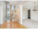 Open entryway featuring hardwood floors, stairs to the upper level, and a view into the living room at 3007 Sandbox Cir, Indian Trail, NC 28079