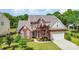 Aerial view of brick home with a manicured front lawn and a large two-car garage at 3007 Sandbox Cir, Indian Trail, NC 28079