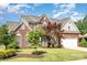 Charming brick home with manicured lawn, mature trees, and attached two-car garage at 3007 Sandbox Cir, Indian Trail, NC 28079