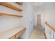 Well-lit hallway with built-in desk and shelves, leading to other rooms and a bathroom at 3007 Sandbox Cir, Indian Trail, NC 28079