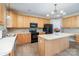 Well-lit kitchen boasts an island, black appliances, and wood cabinets at 3007 Sandbox Cir, Indian Trail, NC 28079