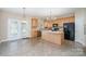 Open concept kitchen with center island, updated appliances, and outdoor access at 3007 Sandbox Cir, Indian Trail, NC 28079
