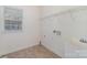 Functional laundry room with a utility sink, window, and shelving for storage at 3007 Sandbox Cir, Indian Trail, NC 28079
