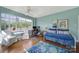 Sunlit bedroom with a daybed, hardwood floors, large windows offering neighborhood views at 301 W 10Th St # 402, Charlotte, NC 28202