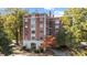 A brick apartment building with classic architectural details, surrounded by lush greenery at 301 W 10Th St # 402, Charlotte, NC 28202