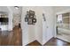 Hallway with hardwood floors and framed artwork on white walls leading into the bathroom at 301 W 10Th St # 402, Charlotte, NC 28202