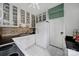 Bright kitchen featuring white cabinets, brick backsplash, black countertops, and vintage appliances at 301 W 10Th St # 402, Charlotte, NC 28202