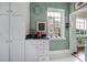 Compact kitchen area featuring tiled floors, white cabinets and countertops, and a vintage phone at 301 W 10Th St # 402, Charlotte, NC 28202