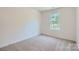 Bedroom with neutral carpet, a window and white walls at 3015 Howell Mill Rd, Charlotte, NC 28208
