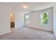 Spacious primary bedroom features two windows, plush carpet, neutral paint, and ensuite bathroom at 3015 Howell Mill Rd, Charlotte, NC 28208