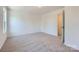 Simple bedroom features neutral colors, plush carpet, lots of light, and attached ensuite bathroom at 3015 Howell Mill Rd, Charlotte, NC 28208