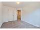 Bedroom featuring neutral carpet, a closet and a view into the hallway at 3015 Howell Mill Rd, Charlotte, NC 28208