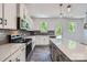 Bright and airy kitchen with island, stainless appliances, gray backsplash, and modern design at 3015 Howell Mill Rd, Charlotte, NC 28208