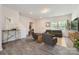 Open concept living room featuring modern decor, gray floors, and abundant natural light at 3015 Howell Mill Rd, Charlotte, NC 28208