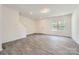 Bright, open-concept living room with sleek gray floors and neutral wall color at 3015 Howell Mill Rd, Charlotte, NC 28208