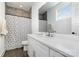 Modern bathroom featuring white vanity, a large mirror, and a shower with gray tiling and a geometric shower curtain at 302 Wesley Heights Way, Charlotte, NC 28208