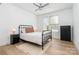 This bedroom features a ceiling fan, hardwood floors, and two windows for natural light at 302 Wesley Heights Way, Charlotte, NC 28208