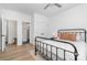 This bedroom features a ceiling fan, hardwood floors, and multiple doors at 302 Wesley Heights Way, Charlotte, NC 28208