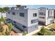 Modern townhome showcasing a sleek design with a mix of gray and blue siding with manicured landscaping at 302 Wesley Heights Way, Charlotte, NC 28208