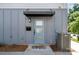 Charming front door with modern design, stylish awning, and inviting curb appeal at 302 Wesley Heights Way, Charlotte, NC 28208