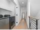 Hallway with wood floor, washer and dryer, and wooden framed mirror at 302 Wesley Heights Way, Charlotte, NC 28208