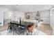 Open kitchen with a large island, stainless steel appliances, and elegant dining area at 302 Wesley Heights Way, Charlotte, NC 28208