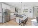 Bright kitchen with a large island, breakfast bar, and stainless steel appliances at 302 Wesley Heights Way, Charlotte, NC 28208