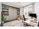 Home office with custom built-ins, a murphy bed, a patterned rug, and a bright window at 302 Wesley Heights Way, Charlotte, NC 28208
