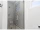 Glass enclosed shower features gray tile and a window at 302 Wesley Heights Way, Charlotte, NC 28208