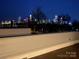 Night view of the city skyline from the rooftop patio at 302 Wesley Heights Way, Charlotte, NC 28208