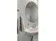 Powder bath with a modern round mirror, clean lines, and a white pedestal sink at 306 Willow Wood Ct, Matthews, NC 28104