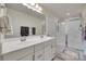 Bathroom featuring a double sink vanity, a large mirror, and a glass enclosed shower at 306 Willow Wood Ct, Matthews, NC 28104