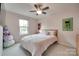 This bedroom offers bright light from the large window and room to spread out at 306 Willow Wood Ct, Matthews, NC 28104