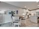 Bright dining area featuring a modern table, white chairs, and a view of the kitchen at 306 Willow Wood Ct, Matthews, NC 28104