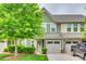 Inviting townhome with a well-manicured lawn, lush green tree, and charming curb appeal at 306 Willow Wood Ct, Matthews, NC 28104
