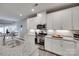 Well-lit modern kitchen featuring granite countertops, stainless appliances, and white cabinetry at 306 Willow Wood Ct, Matthews, NC 28104