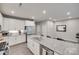 Bright, modern kitchen with island, white cabinets, stainless appliances, and granite countertops at 306 Willow Wood Ct, Matthews, NC 28104
