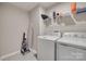Bright laundry room with modern washer and dryer set, and convenient shelving for storage solutions at 306 Willow Wood Ct, Matthews, NC 28104